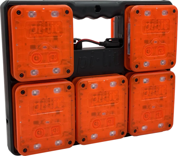 A 10-flare set of orange pi-lit Smart Sequential Road Flares docked in the charging carrying case.